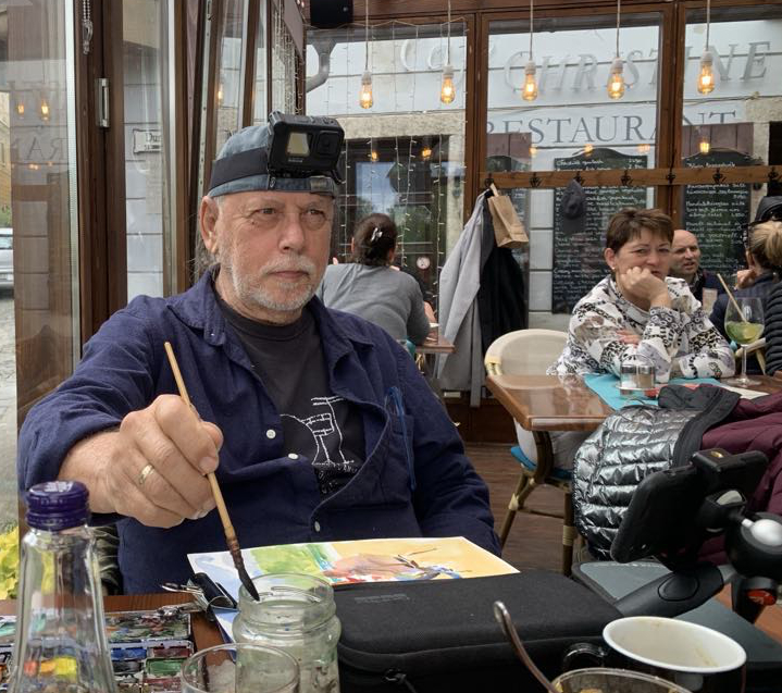 Josef Rapaport sketching in café